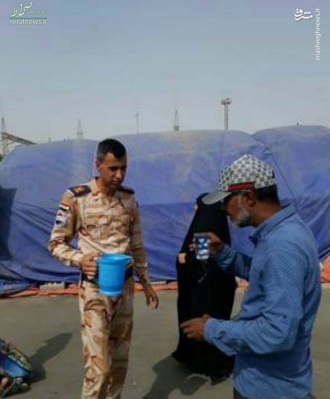 عکس/ پذیرایی افسر عراقی به زائران
