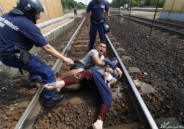  پلیس مجارستان و یک خانوده پناهنده که سعی داشتند در ایستگاه قطار در شهر بیکسکه مجارستان بگریزند.