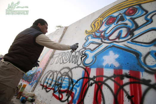 کاریکاتوریست عراقی با ترسیم نقاشی‌های دیواری، اعتراض خود را به تصمیم ترامپ درخصوص ممانعت از سفر عراقی‌ها به آمریکا نشان داد
